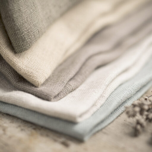 Closeup,Shot,Of,A,Pile,Of,Folded,Dull-colored,Cotton,Fabric.